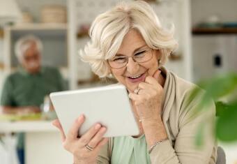 Retired woman enjoying tablet